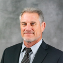 Mark Gumble is a white man wearing a dark suit